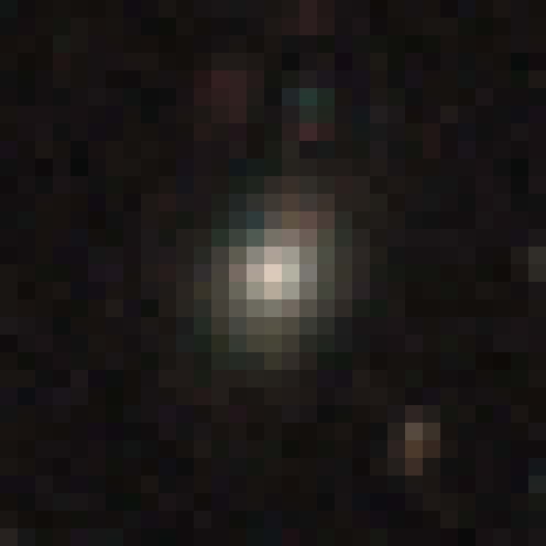 A small, round, fuzzy galaxy at the centre of a dark pixelated image.