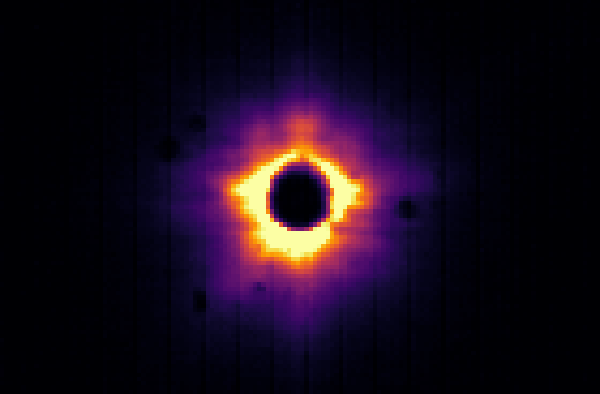 The guiding-camera image: a bright ring of starlight around the dark fibre hole, with faint vertical stripes from the detector.